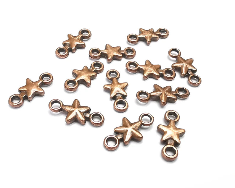 10 Star charms are made of nickel free and lead free antique copper plated zinc alloy metal. Size : 14x7 mm.