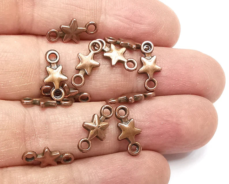10 Star charms are made of nickel free and lead free antique copper plated zinc alloy metal. Size : 14x7 mm.