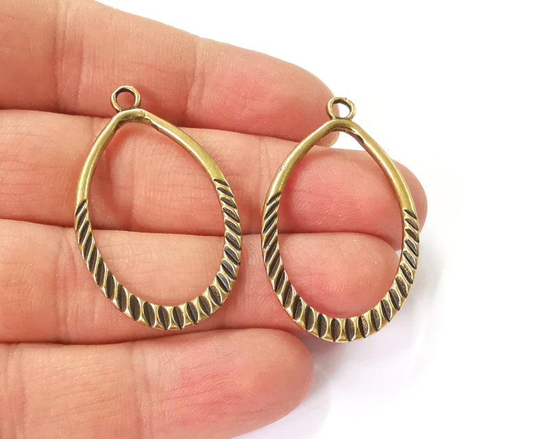 4 Ribbed oval charms Double sided antique bronze plated charms (42x25 mm) G24559