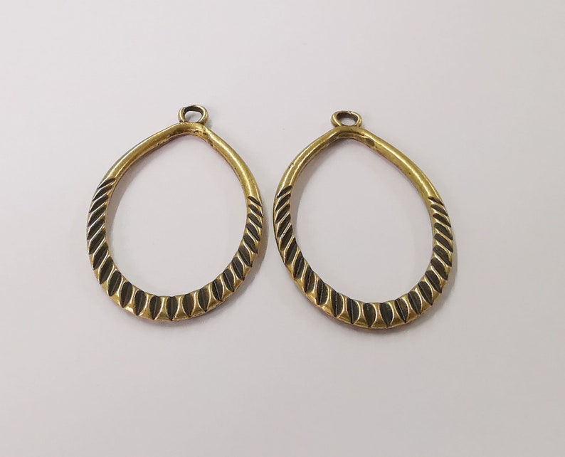 4 Ribbed oval charms Double sided antique bronze plated charms (42x25 mm) G24559