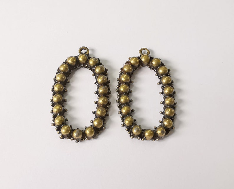 2 Antique bronze charms Antique bronze plated charms (38x22mm) G25218